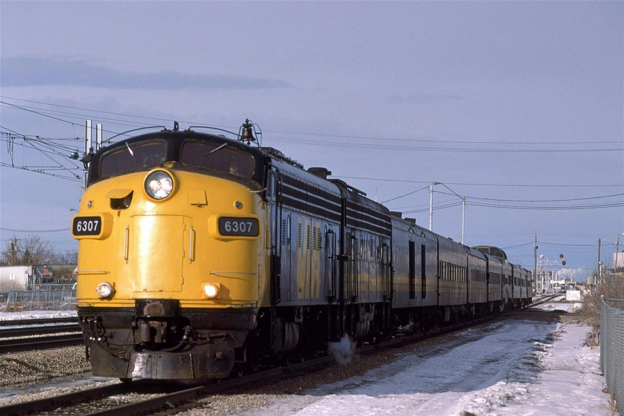 The westbound "Super Continental" is about a mile from the downtown VIA station. It is still on the Wainwright Sub, however, as it has veered SW from the mainline at East Junction. Had it gone straight, it would have gone onto the Calder Yard entry on the north side of town, and bypassed the downtown altogether.
Northlands Coliseum may be seen at the right edge of the photo. 
This would be my last photo of an old F unit leading a VIA train.