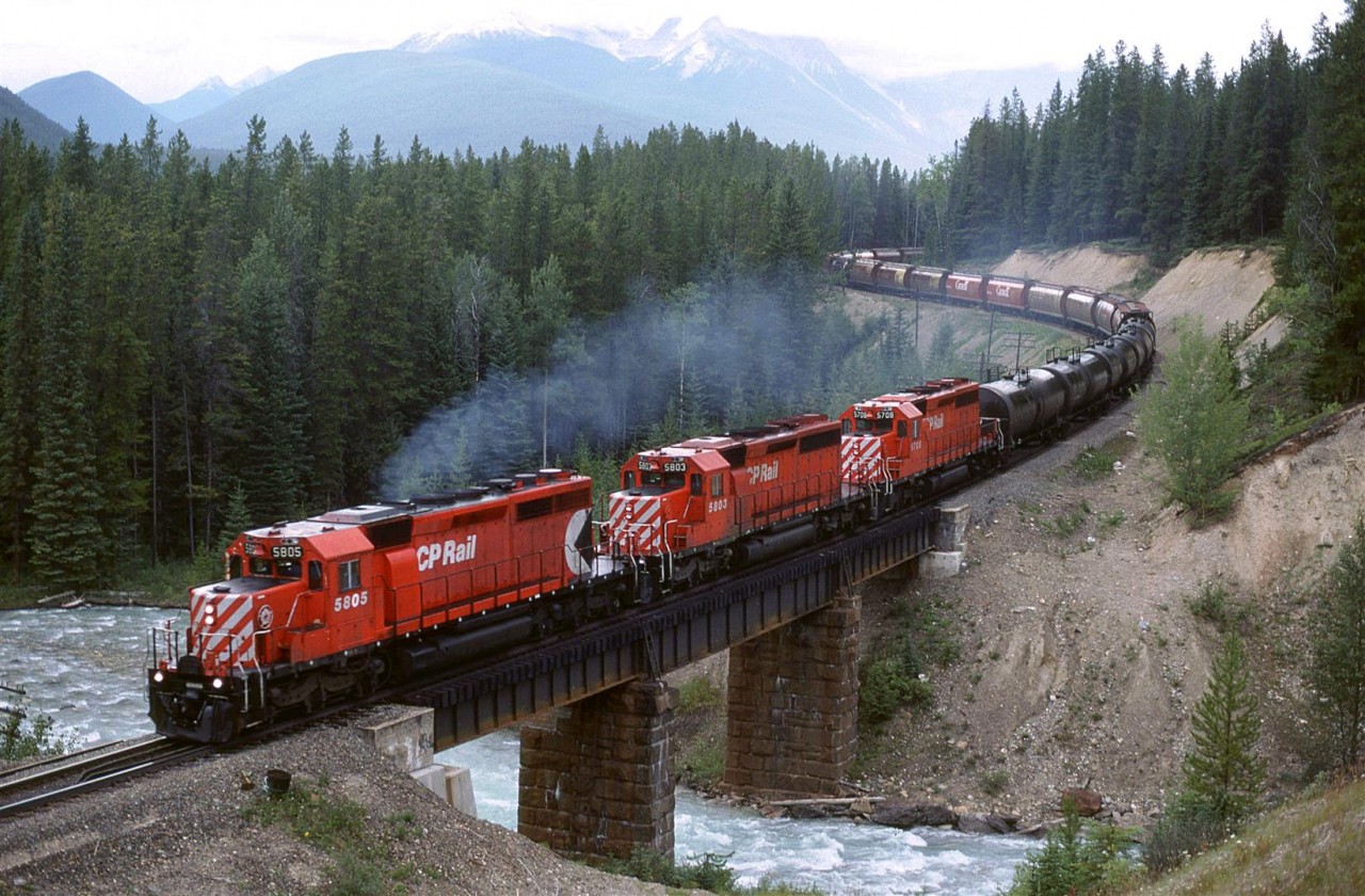 In order to show my railfan acquaintance how one can chase a train from the summit of Kicking Horse Pass all the way to Golden - the area covered by his planned guide, we decided to chase this train. The next several photos were all taken from roadside locations. This was our sixth photo location, just before Ottertail siding. I have seen a recent photo of this location and there are some less-than-attractive power lines adjacent to the tracks opposite the highway.