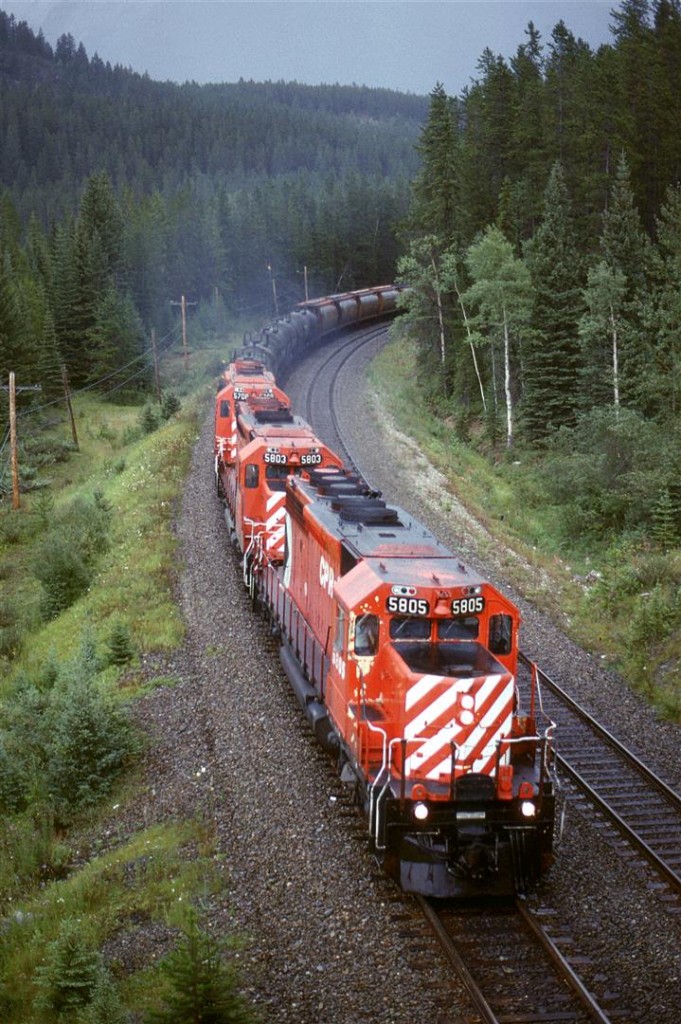 In order to show my railfan acquaintance how one can chase a train from the summit of Kicking Horse Pass all the way to Golden - the area covered by his planned guide, we decided to chase this train. The next several photos were all taken from roadside locations. This was our seventh photo location, near the eastern end of Leanchoil Siding as the tracks pass under the highway, again. And, as is often the case, the weather was quite variable. There are not that many photo opportunities for the next few miles until the highway, railway and Kicking Horse River get constricted at Glenogle.