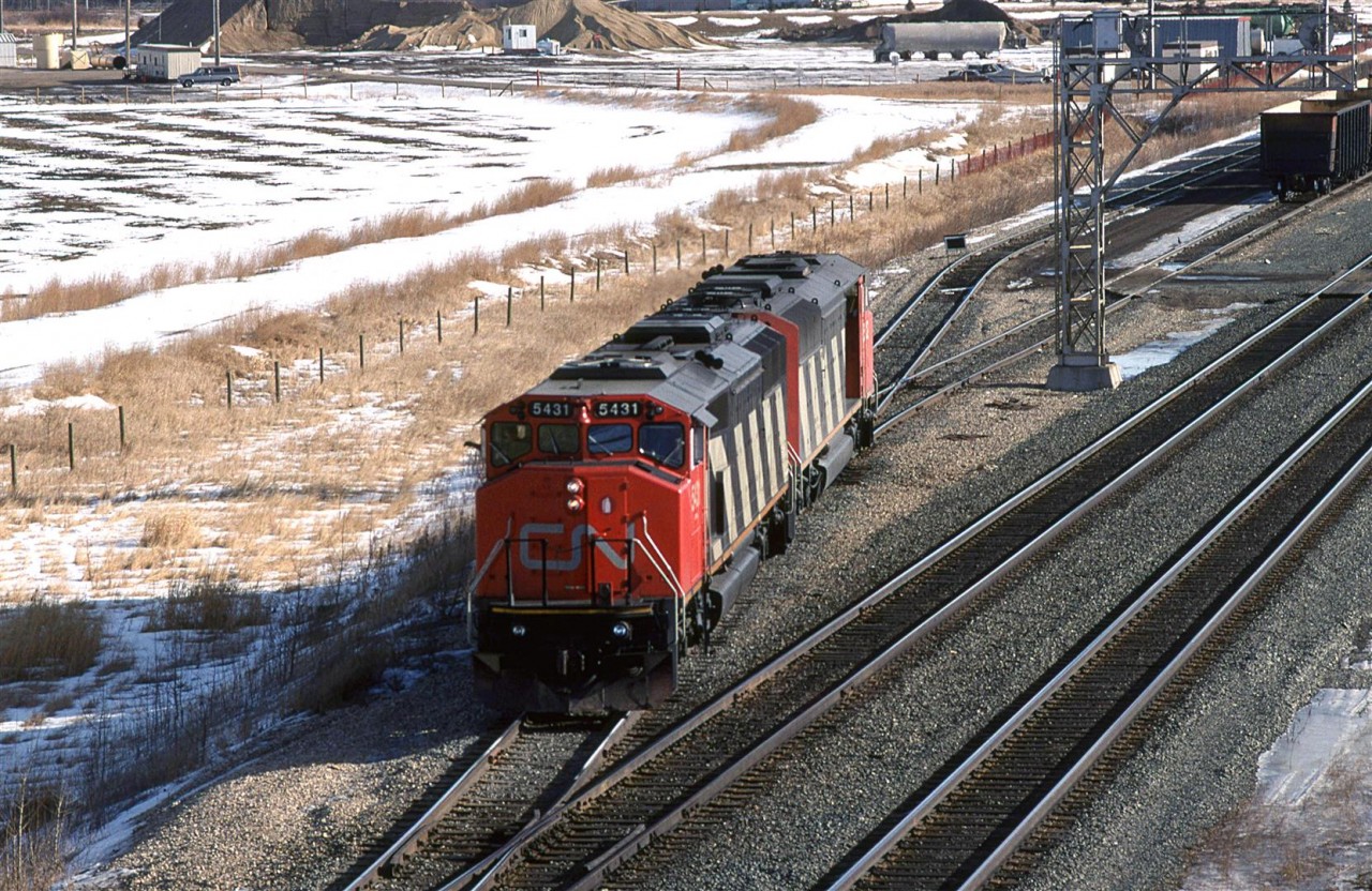 A couple cowled SD50's are about to couple onto their empty sulphur train at the west end of Bissell Yard. After their air test, they will back the train to the east end of the yard to Union Junction. From there, they will proceed forward up the Sangudo Sub all the way to Kaybob for loading.