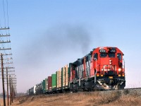 Looking a lot like a local, this regional train, #452 from Edmonton to Winnipeg is just beginning its journey on the Wainwright Sub out of Edmonton.
The pole line is still there but not for much longer. Look carefully, there is still a caboose on this train. 