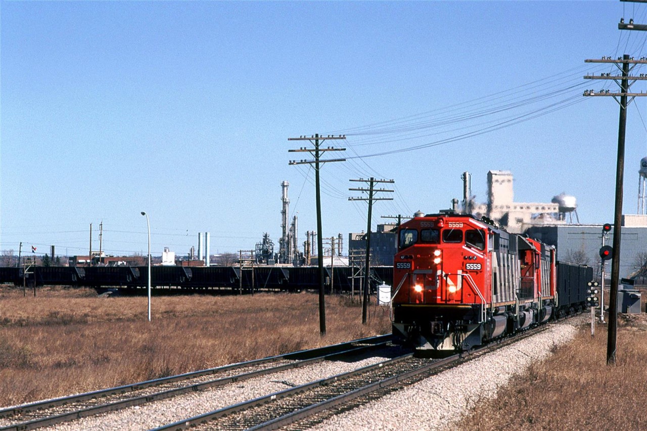 This empty Sulphur train is rounding the wye at Brettville Junction to head south down the Camrose Sub. At Alex Junction, it will go west on the Brazeau Sub to the sour gas fields near Rocky Mountain House for loading.
In the background is the Celanese chemical plant and Edmonton Power's generating plant (both now razed).