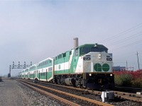 This morning started out dark and foggy, but that soon changed. 
An eastbound GO train zips by the Ford plant adjacent to the CN yard. I believe that this is a Sunday morning, which explains the short train on the Lakeshore route.