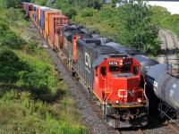 CN SD60 5476 and SD70M-2 8958 crawl past Wayne Gretzky Parkway as they slowly get back underway with Q14891 13. I believe they had gone into Emergency around Hardy for several minutes beforehand