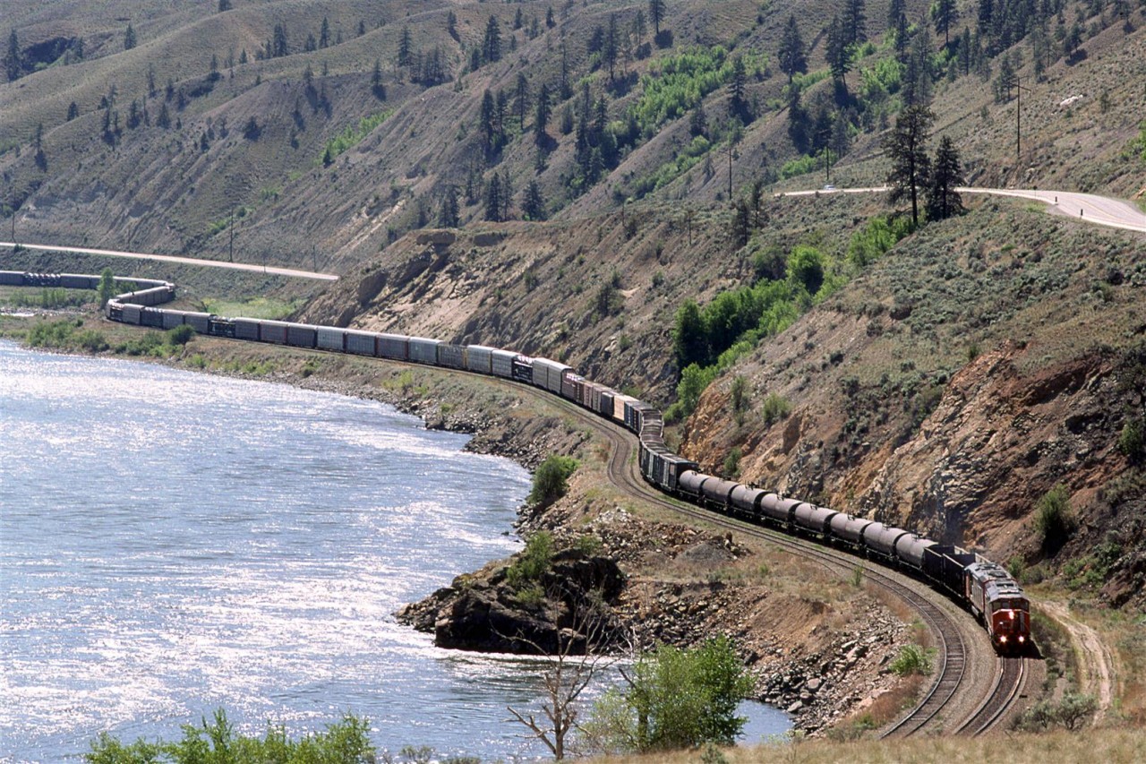 This is probably train 218, based on the auto racks and tank cars in the consist.
It is working uphill along the Thompson River, upstream of Spences Bridge.