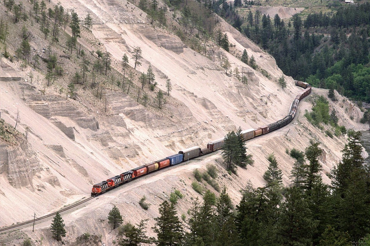 A mixed train, possibly #217, treads gingerly along the bench cut into the poorly consolidated sediments in the eastern end of White Canyon. This must be a very expensive piece of RR to maintain.