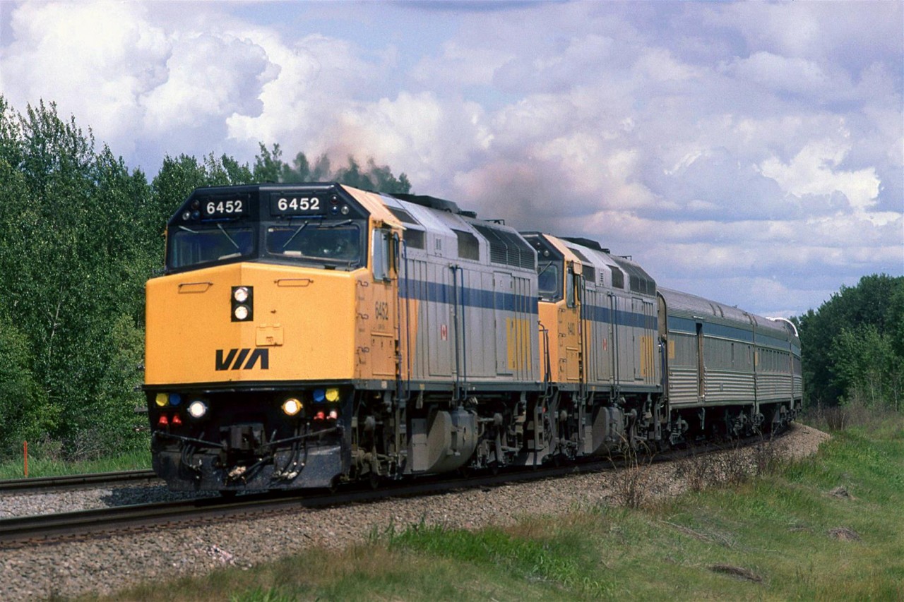 The westbound "Canadian" rounds the second large curve around Mink Lake at Carvell.