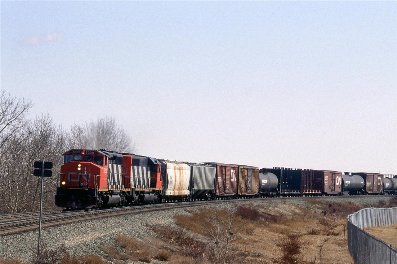 Not looking much like a high priority train this #219 is approaching 50 St (then, a level crossing) in eastern Edmonton. That double tracking was put in about a year ago.