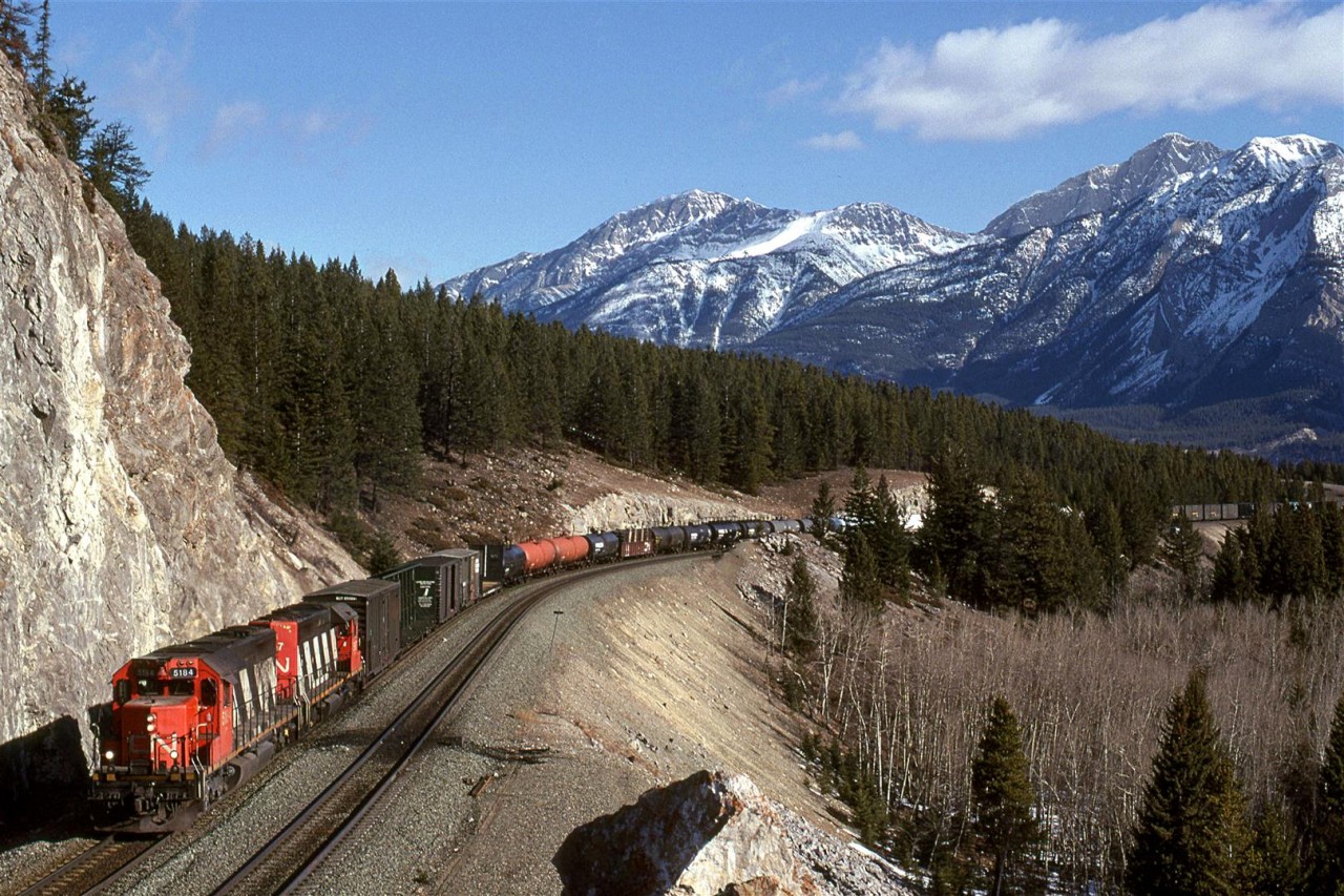 Empty wood product cars dominate this train destined for Prince George. It is approaching Jasper.