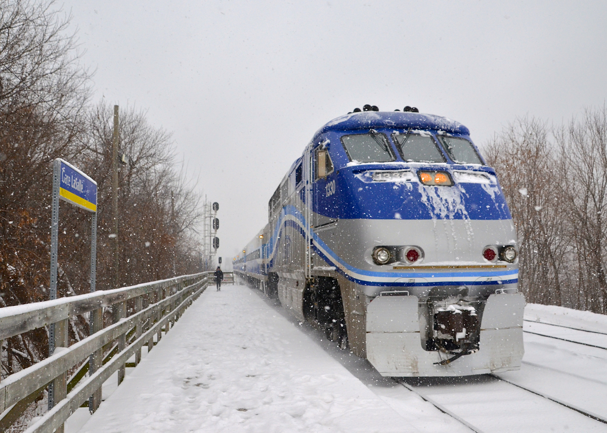 AMT 84 is on time as it arrives at Lasalle Station on the morning of a snowstorm in Montreal with F59PHI AMT 1330 leading.