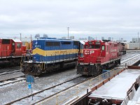 Ready to be shipped out are Dakota Minnesota & Eastern 6071 "City of Fort Pierre" an ex CP SD40 #5520 and GP9u 1594 now property of OSR. To the right of the 1594 with the flatcar is the materials department track.