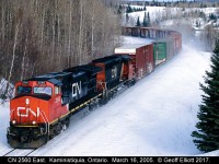 CN 2560 leads an eastbound around the curve near Kaministiquia, Ontario on CN's Kashabowie Subdivision on a cold March 16th back in 2005.  The train is about to pass under Highway 102 as it continues east toward Thunder Bay, Ontario.