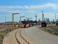 Looking west towards the Diesel Shop at the very centre of the photo behind the stored plow and spreader. Much of the power is now disposed of as one can see various ICE/DME units to the left. The 3 tower like structures are the sand towers of the servicing island.