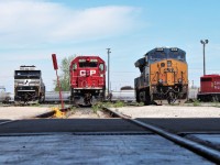 Norfolk Southern SD60E 6960 and CSX ET44AH 3366 sandwich stored CP GP38-2 3123 at the east end of the shop.