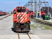 Sold GP9u sits past the locomotive servicing island where a pair of trains are being readied to dispatch.