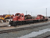 A view of the 2 ex Agincourt hump units with their engines exposed while the CAT machine works behind the cab of the 6618 crunching up the unusable metal.