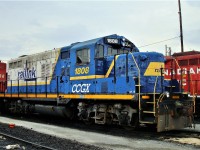 Former Railink GP10 in transit through Agincourt. Note that someone took the time to spray paint a smiley face on the draft gear.