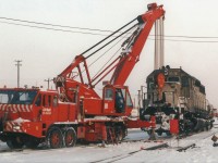 One of the rent a wrecks from the late 90's an ex-KCS SD40 gets it's front truck re-railed with the assistance of the Pettibone mobile crane.