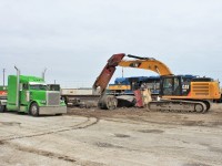 While ICE 6101 waits in the background the CAT heavy equipment has a chain attached to the bottom of the claw and the main alternator which will be lifted onto the "Lime Green Machine" rig. 