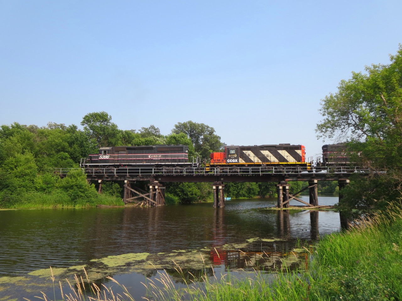 CEMR 5396 leads CCGX 4119 and CEMR 4002 across the LaSalle River in Sanford, MB. The assignment this day is an extra grain train, loaded and headed back to Winnipeg to be handed over to CN.