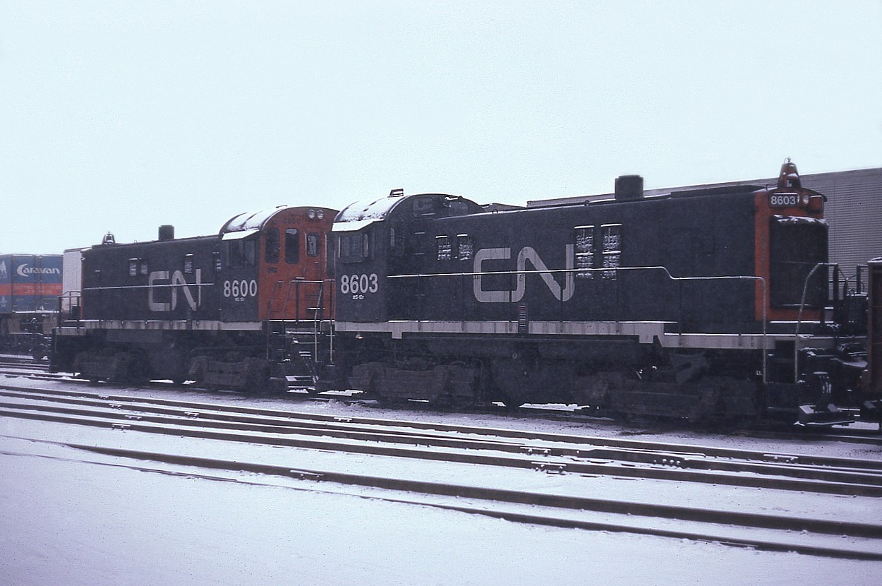 Miserable snowy day in early winter, but it still did not discourage me from wandering around to see what was happening trackside.
In Hamilton's Stuart St yard the locals had been working.......I don't believe these were based here at the time but rather came in from Aldershot and beyond. And perhaps 'overnighted'.
CN 8600 and 8603, nice pair of S-13s, of which these two, which were soon renumbered to 300 and 303 according to my trackside guide for 1983.
Information other than what is in the guide would certainly be appreciated.