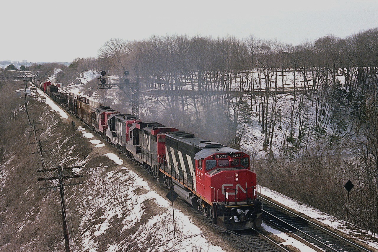 Running from Fort Erie to Toronto, train #432 is photographed from then almost new Walkbridge over the tracks at the Royal Botanical gardens. Power is CN 9571, with 3 GP9s trailing,  4513, 4577 and 4567. I did not take a car count but did note the caboose was #79395.