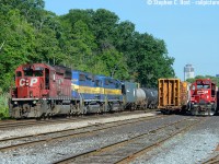 Here's a hot hazy summer day photo to warm us up. I posted a shot of this train <a href=http://www.railpictures.ca/?attachment_id=10402 target=_blank> some years ago</a> (back in my wide angle - not sure how to use it - days) but I've pulled out this more standard angle out that I much prefer - a classic TH&B view with some of the Hamilton skyline in view - and now, most  if not all of this motive power is no longer on the roster. Boy how good we had it then.. little did I realize most of this would dissapear in a couple short years. I didn't chase this.. I should have - we would chase the piss out of this now.