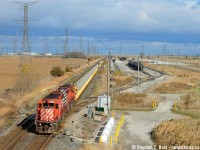 Fall is a neat time of year where fields of green turn to gold but only for a few weeks before the snow flies. In late November I was able to photograph a pair of venerable action orange SD40-2's passing what was the Milton Expressway terminal, now a liquids transfer facility operated by Cando Rail Services. What's neat is from this overhead view you can clearly see the 5 sections of these cars owned by <a href = https://georgetownrail.com/Material-Handling/SlotMachine-and-SPS target=_blank>Georgetown Rail Services</a> where the ballast was loaded the previous day at Fisher-Wavy in Sudbury.

