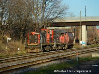 The 1400 is coming out of "the hole" passing the Dwarf at 0.01 N&NW spur governing movements back onto the Oakville Subdivsion. Naturally what dragged me out this evening was 1444 in the lead on a nice spring evening - the Government of Canada hopper lifted from CVO (Bunge) Bayside is an extra nice touch IMO.<br><br>The only problem with Hambone, as Arnold affectionately calls Hamilton is the roughness of it all near the tracks, and it's only getting worse. Let's just say the squatters found by the rail line are none too friendly anymore, and if you venture off any beaten path you have to beware of things like used Needles and the like. But I went under a pedestrian bridge to get this shot - not sure I'll do it again. One thing is for sure - make sure you have  puncture proof safety boots (which I wear due to work). I'm honestly starting to think twice of some of my Hamilton adventures in the past few years! Sticking to grade crossings and public walkways generally OK (Victoria Ave ped bridge by candy factory - be careful though! - squatters)