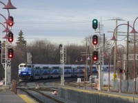 F59PH AMT 1344 leads EXO 112 around a curve as it approaches the Westminster Avenue crossing and then Montreal West Station. At right a deadhead move is lined westwards.