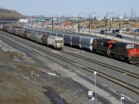 CN X309 with CN 2685 & CN 3145 for power has 171 grain empties (including some relatively new CN hoppers) as it approaches Turcot Ouest where it will change crews. At left two tracks of the Montreal Sub (track 29 and the freight track) have loaded grain cars stored on them.