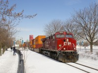 CP 118 with CP 8008 has temporarily advanced onto CN's Wharf Spur (presumably for headroom) and is stopped, blocking a couple of crossings. After a 15 minutes or so wait it will back up towards Port of Montreal trackage.