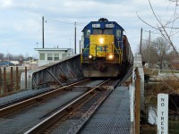 I don't post portrait shots very much, but this angle calls for it only because of the unique "no trespassing" signs that I have no doubt are quite old. D724 is southbound crossing the Wallaceburg drawbridge with 18 cars in tow. The crew would set off some cars in the Wallaceburg siding, run-around at Dresden, and had work at London Agricultural Commodities (Tupperville), IPC in Wallaceburg (old Glass plant) and Liquid Air (Sombra). At top right is the RTC/Bridgetenders office, at this time the RTC was on duty 24/7 despite only two trains a week into the OCS.