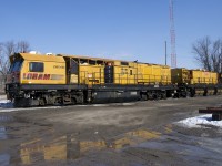 A Loram rail grinder is at rest near the venerable Napanee Station, built by the Grand Trunk Railway in 1856 and barely visible at right.