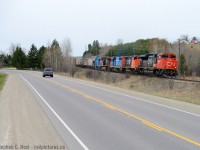 This is a shot i'd never try on a regular day as there are far too many vehicles and trucks on HWY 7 - you'll almost certainly get something blocking the train. These are not regular days and neither is this train -  L533 is leaning into the curve just east of MP45 with a typically large train and an interesting gaggle of motive power variety, but it was the GTW unit in Daylight that got me out of the house. Even still, 533 in Daylight doesn't happen all that often (once or twice a month?). Too bad it wasn't sunny or it would have been even better. In the background is the Jones Baseline overpass.