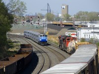 CN 527 awaits the passage of EXO 1209 before it can get its signal and continue its eastwards voyage to Southwark Yard. EXO 1209 consists of F59PH AMT 1348 and six multilevel cars and is on its way to Mascouche.