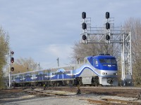 After makings its station stop at Lasalle Station EXO 76 is on the move again as it passes under a signal gantry.