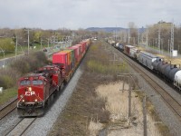 CP 119 is overtaking CN 377 as it heads west through Pointe-Claire with CP 8136 & CP 8102 up front and CP 8742 mid-train. It is passing over a section of freshly ballasted track.