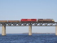 SD70ACU's CP 7010 and CP 7002 lead CP 253 over the St. Lawrence River. This is the second time in under a week that this pair power this train.