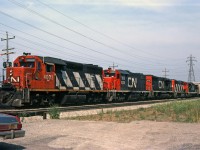 Five different types of GMD locomotive power this CN train on the Grimsby sub in mid-July 1980.<br>
Leading is CN 4003, second CN GP40 in the series built 1966; it would be renumbered CN 9303 in 1981.<br>
Second is GP38-2 CN 5530 built 1973, it would be renumbered CN 4730 in 1988.<br>
Following are SD40 CN 5036, GP40-2(w) CN 9650, and GP9 CN 4535.<br><br>
Based on current streetviews, looks like this train was heading west toward Hamilton.
 