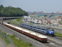 AMT 1344 leads EXO 1207 past cars which are stored on both track 29 and the freight track of CN's Montreal Sub. At the right in the background is the newly rebuilt (and not quite finished) Turcot interchange. Nearly all of this space was part of CN's Turcot Yard, which closed in 2002.