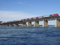 CP 253 has CMQ 9023 trailing CP 8113 as it approaches the island of Montreal on CP's impressive bridge that spans the St. Lawrence River.