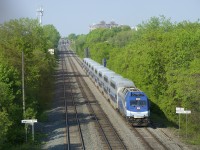 EXO 174 has AMT 1362 and nine bilevel cars as it heads east on CP's Westmount Sub.