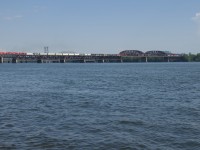 CP F94 is returning to the island of Montreal with 5 geeps
(CP 2279, CP 4417, CP 2307, CP 2318 & CP 2280) and about 130 cars as it crosses the St. Lawrence River on a scorching afternoon. This is all traffic coming off the recently acquired CMQ, in fact CP F23 from Farnham brought this traffic to Iberville, where CP F94 picked it up. Iberville is where CMQ and CP used to interchange trains; even though the CMQ is now owned by CP, union regulations may dictate that trains still be interchanged there, for the time being.