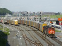  In what must surely be seen as a sign of the economy slowly starting to come back to life, CN X271 with CN 8830 and CN 5684 is passing Turcot Ouest with 110 empty autoracks, which had been stored in the St-Apollinaire siding at MP 20 of CN's Drummondville Sub. It is passing a long string of autoracks which are still stored on the freight track of CN's Montreal Sub. A CN 271 originating out of Taschereau Yard with more autoracks coming out of storage would run a couple of hours behind X271.