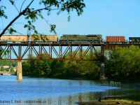 A westbound train, that's all I knew and it will hit the good light after 6:30 PM in Galt - so I went for my first attempt at the Galt Bridge in 2020 - something I usually only do a couple times a season. Clearance 131 to the the 8918 west, proceed from Begin/End CTC Sign Guelph Junction to Ayr. Rats, but I was in for a penny, may as well go for the pound. Upon arrival I composed my shot, the train turned out to be a single unit wonder, but then I'm thinking, what if it's DPU? Jackpot! This 651 was also quite interesting, single engine up front, mainfest, a GREX ballast train, more manifest including the usual OMYA cars, more gondolas (pictured), DPU, more manifest, then the usual 651 ethanol cars. A very long train too. 15 years ago it would have been 3 trains :)



