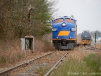 The last two weeks of the OSR's operations on the Cayuga subdivision were remarkable for a couple reasons. On this day it was the first time a pair of F units ran all the way from St. Thomas to Tillsonburg on the line. While F units did run to Aylmer on the St. Thomas job, they never did run east of Aylmer in a pair until April 23. A single F unit with a geep made the trek a few times, but was never a pair. A week later, OSR would run matching F units for the first and last time - the OSR boys really know how to go out in style!<br><br>OSR has just finished pulling the 2 flatcars from the Loop Line Transfer and is working the former CNR/CPR/NS yard, remarkably the eastbound home signal for the CPR/CNR crossing in Tillsonburg still stands after all this time as pictured above. The CPR tracks were removed in the late 1990's i'm led to believe, but I stand to be corrected on that one.  Folks who were there informed me there was a yard on the south side still standing when OSR took over in '97 but CPR quickly ripped it out.