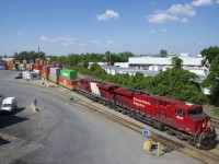 The last CP ES44AC to have part of its Olympic paint scheme intact (CP 8876) is trailing CP 8920 as CP 119 makes a lift at Lachine IMS Yard.