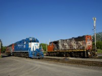 CN 536 with GMTX 2293 and CN 4141 is passing parked CN 4771 as they do switching behind Coteau Station.