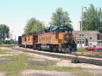 While puttering around at the Chessie facility I just happened to look back over behind me and there was B&O 3835 and a couple of vans in tow; a local working back to the yard. The scene show the train crossing Elm St near Wilson, entering the yard property. Like many of the photographers, I really miss this place.